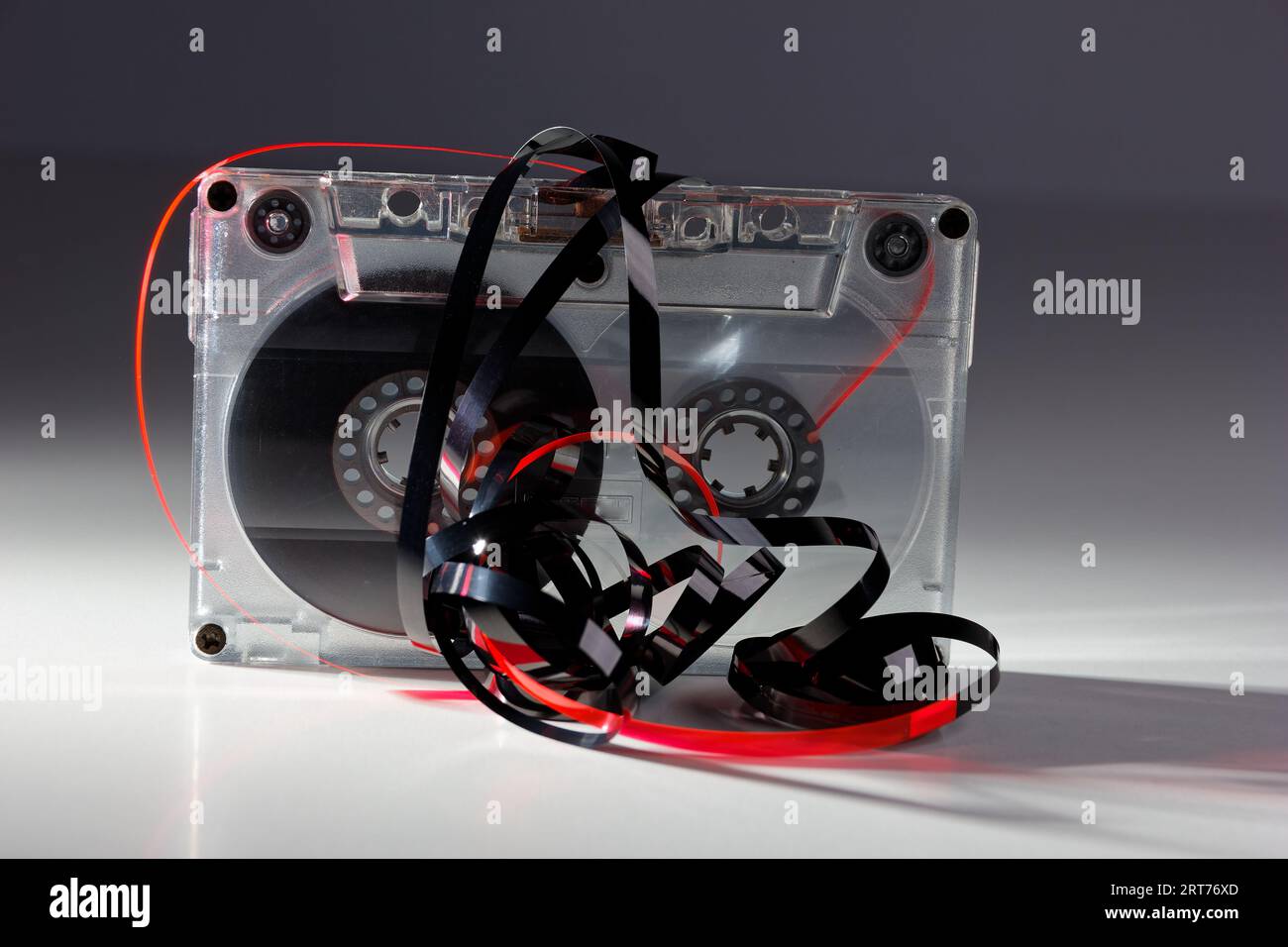 vintage analog audio cassette with transparent case and jammed tape