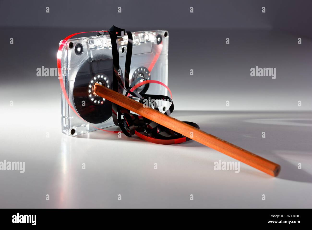 vintage analog audio cassette with transparent case, jammed tape and