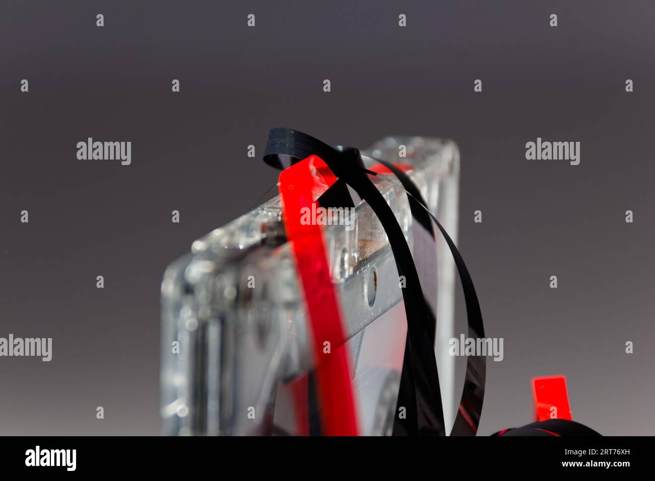 vintage analog audio cassette with transparent case and jammed tape