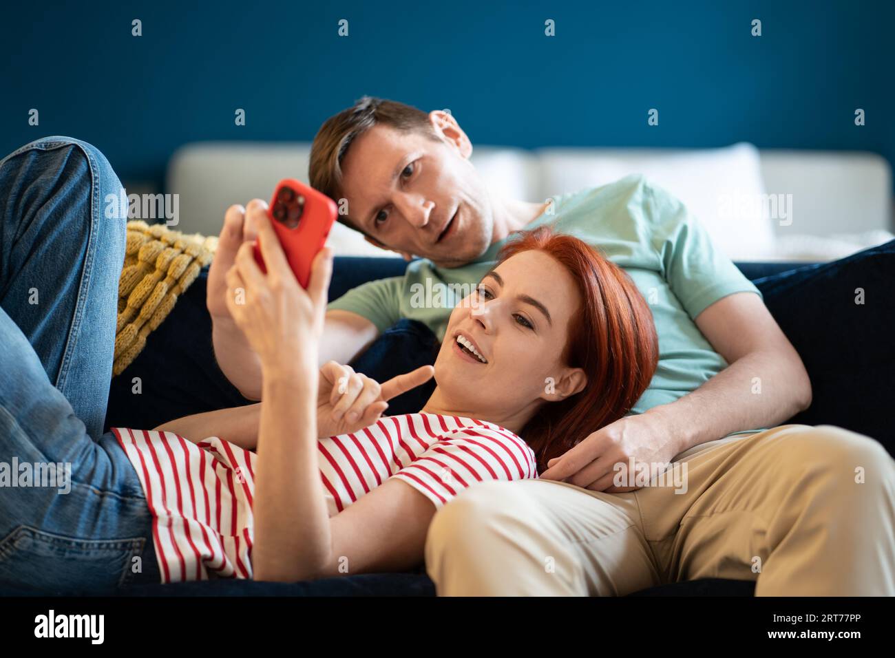 Happy family wife husband watching video in internet, scrolling social  media, sharing news Stock Photo - Alamy