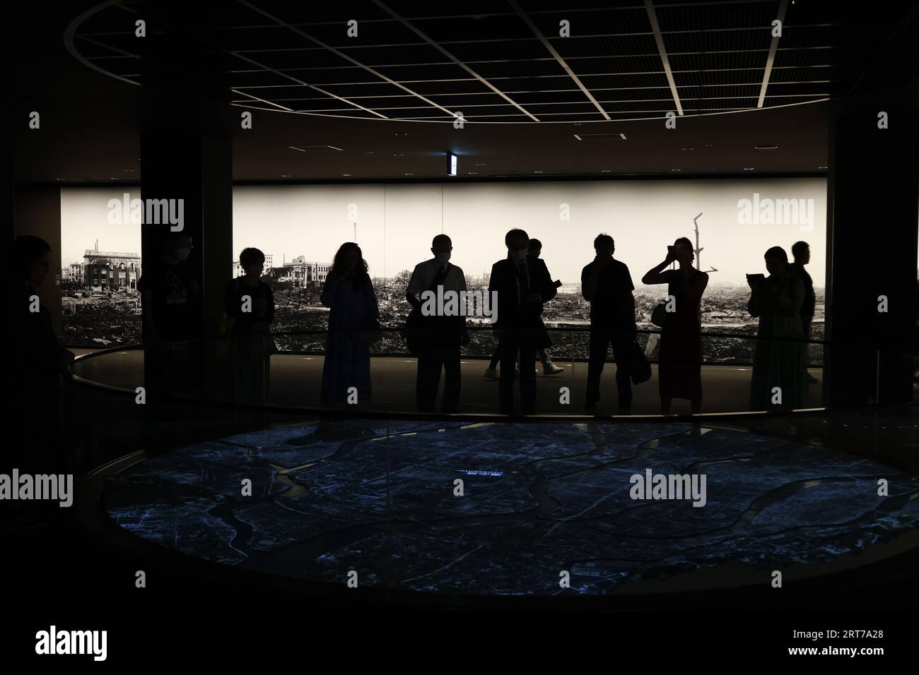 Visitors look at the photographs depicting the aftermath of the bombing ...