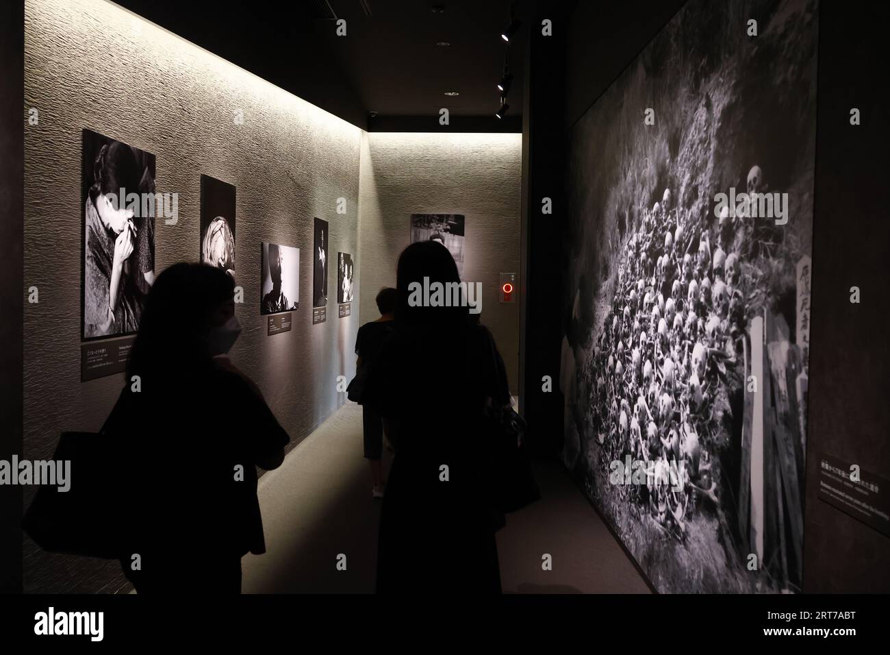 Visitors take a look at the photographs depicting the aftermath of the ...