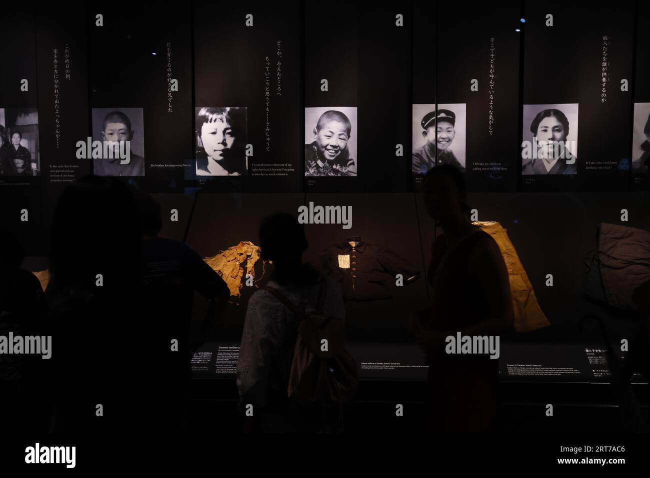 Visitors take a look at the photographs depicting the aftermath of the ...