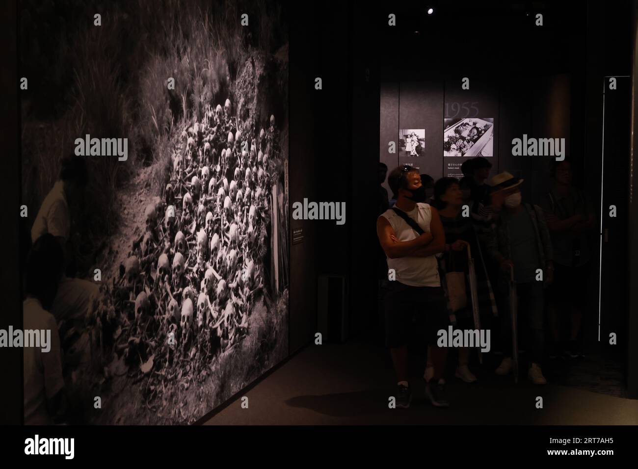 Visitors take a look at the photographs depicting the aftermath of the ...