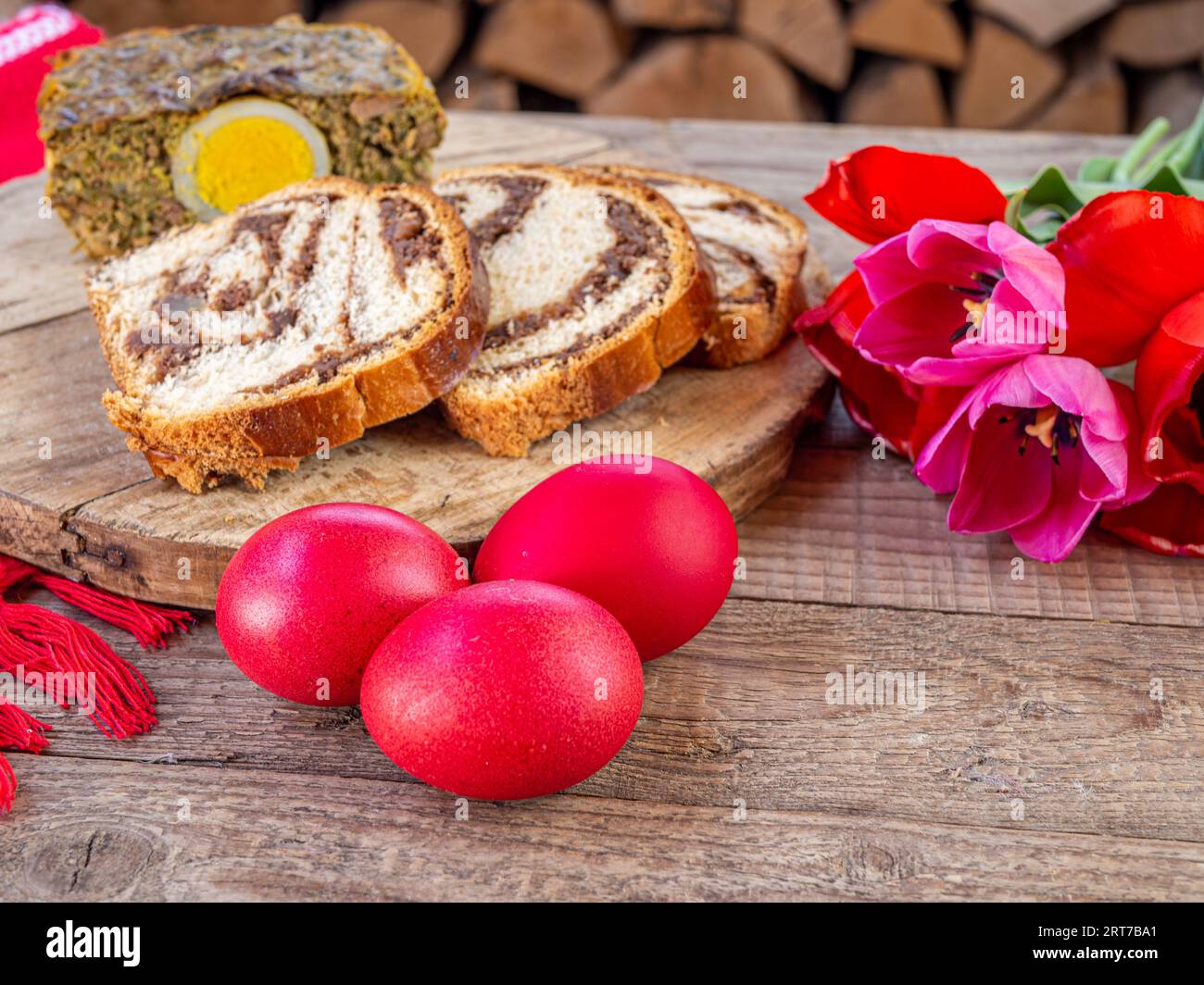 lamb tripe meat cake, sponge cake and colored easter eggs on table Stock Photo