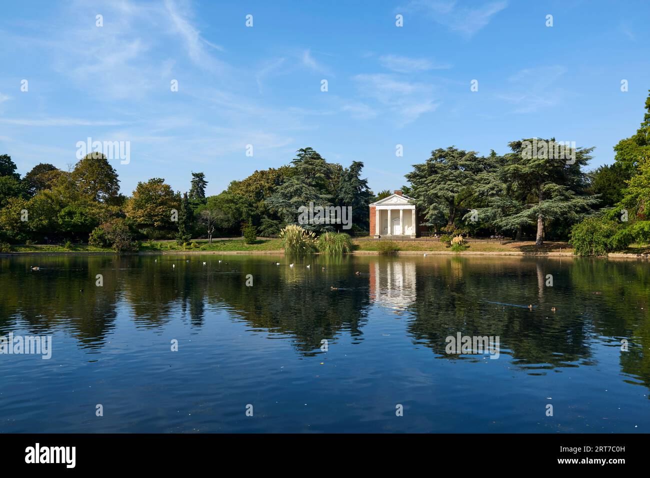 Round Pond, Gunnersbury Park, West London UK, with the 18th century Doric temple, in summertime Stock Photo