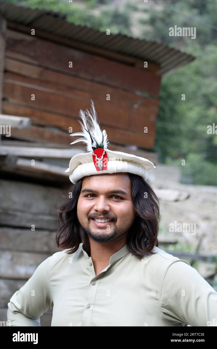 Chitrali man wearing a traditional hat with the Markhor Insignia Stock Photo