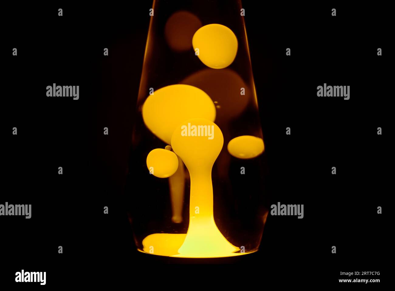 Yellow lava lamp, black background, horizontal format with copy space Stock Photo