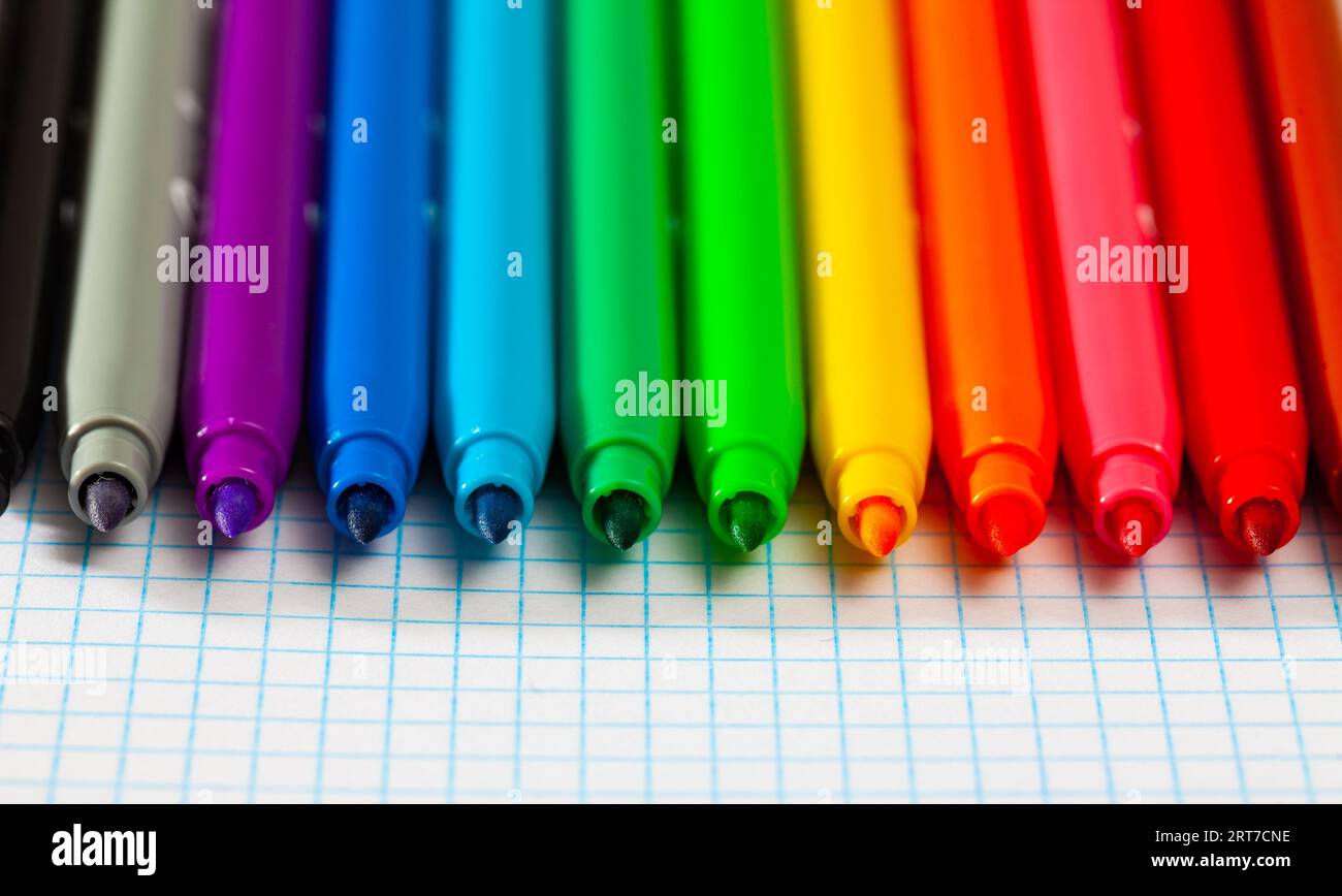 Image of opened multicolored markers on notepad Stock Photo