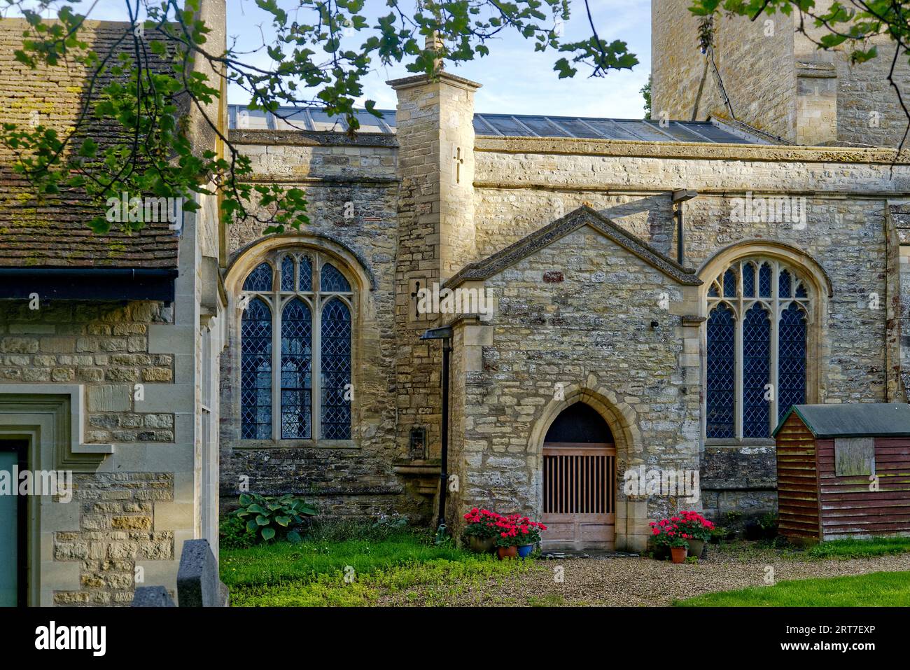 Porch and windows on the southern aspect of St Peter's Church in the Bedfordshire village of Sharnbrook, England, UK Stock Photo