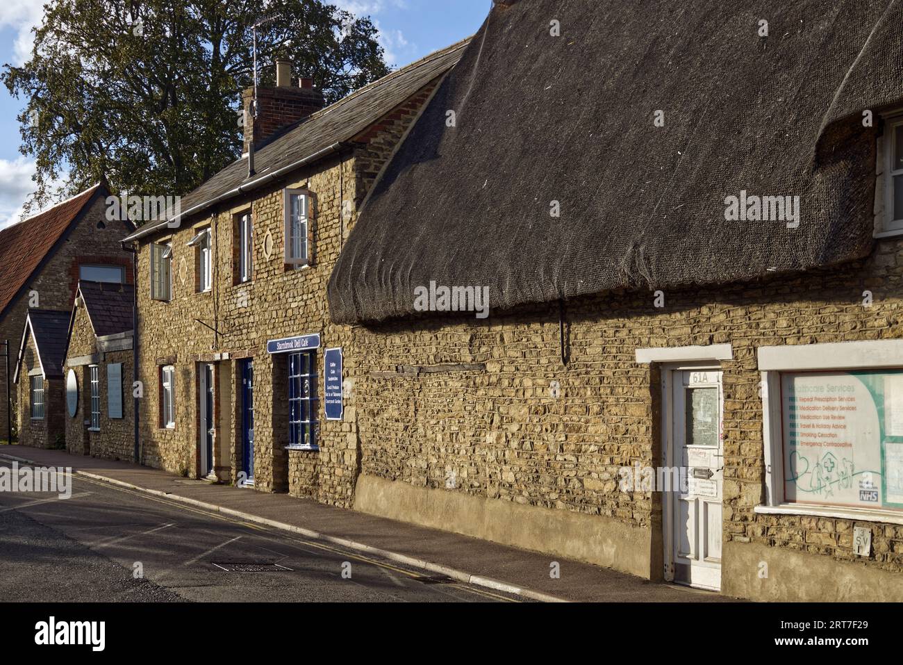 Deli cafe and thatched chemist shop in the High Street of the Bedfordshire village of Sharnbrook, England, UK Stock Photo