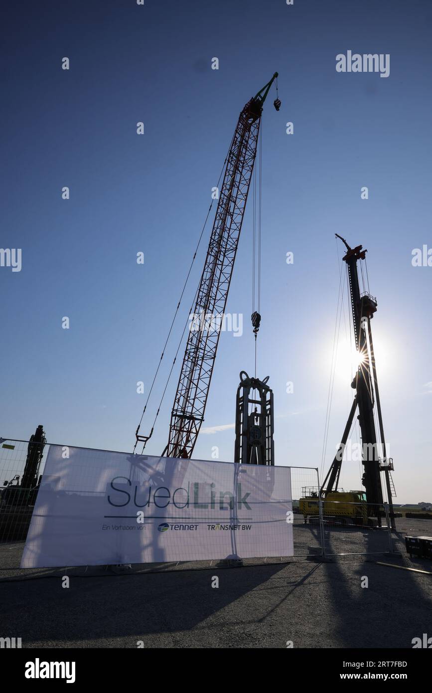 Wewelsfleth, Germany. 11th Sep, 2023. The sun is behind two construction machines on the building site at a press event for the official groundbreaking of the 'Suedlink' electricity transmission project. According to Tennet, the Suedlink route is 700 kilometers long and costs around ten billion euros, making it the largest infrastructure project of the energy transition in Germany. Credit: Christian Charisius/dpa/Alamy Live News Stock Photo