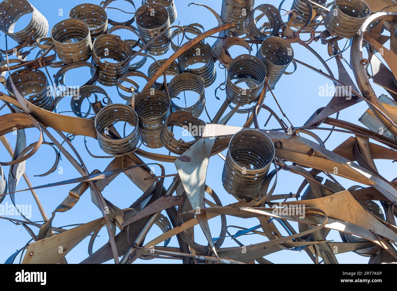 An abstract metal fine art sculpture in Le Barcares, South of France against a clear blue sky Stock Photo