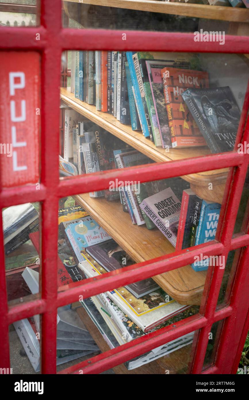Books are seen through the window of a public phone box in the Cotswolds village of Sheepscombe, on 8th September 2023, near Stroud, England. Since the early 17th century, Sheepscombe was involved in cloth making like many of the Cotswold towns in the area and its near neighbour Painswick. Stock Photo