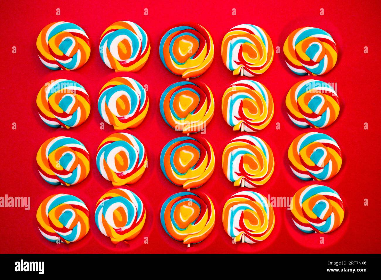 Colorful spiral lollipop candy . On a red background. Stock Photo
