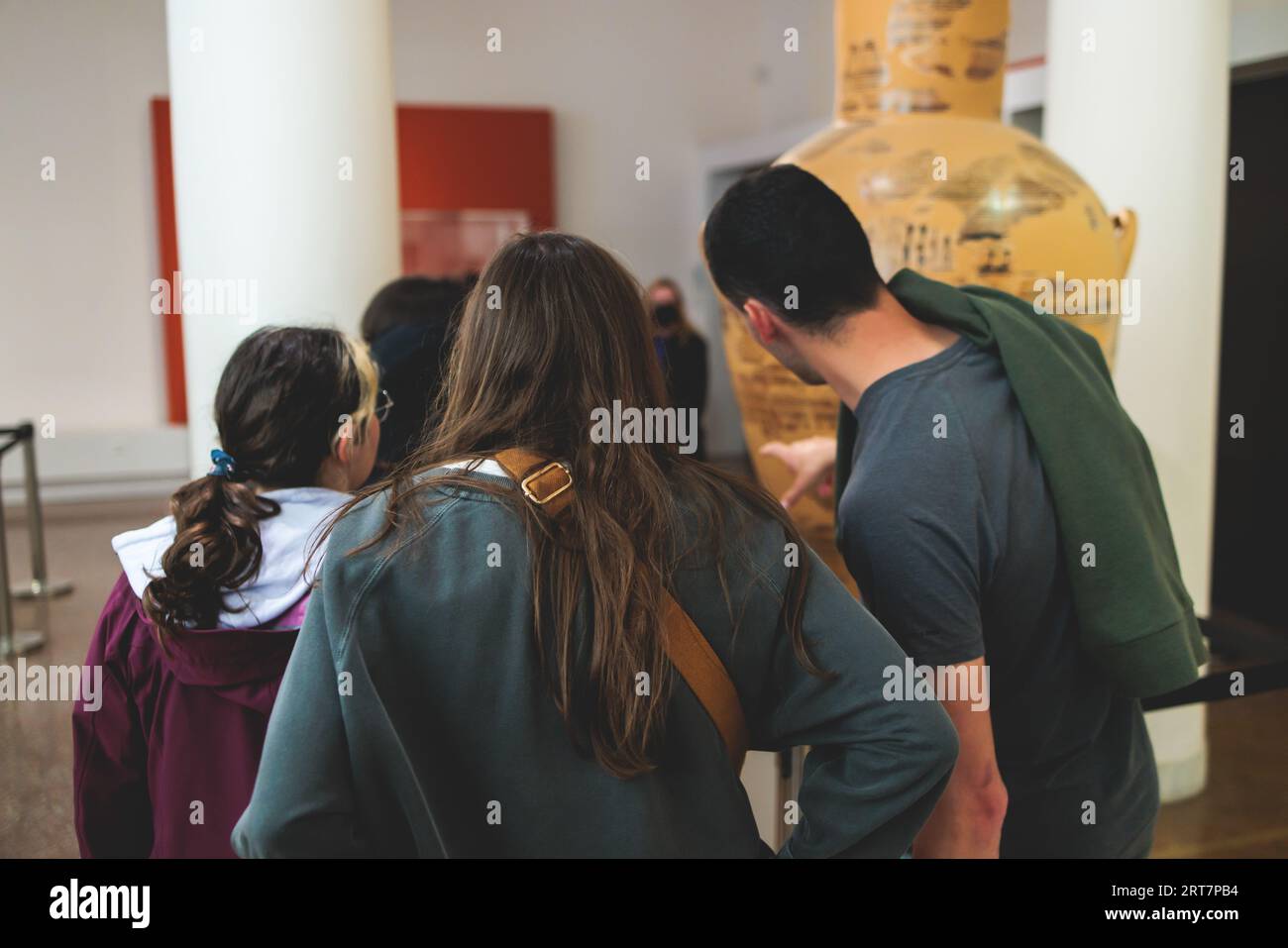 Group of students on excursion tour visit gallery museum with tour