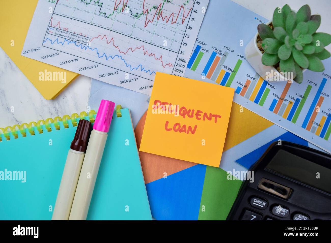 Concept of Deliquent Loan write on sticky notes isolated on Wooden Table. Stock Photo
