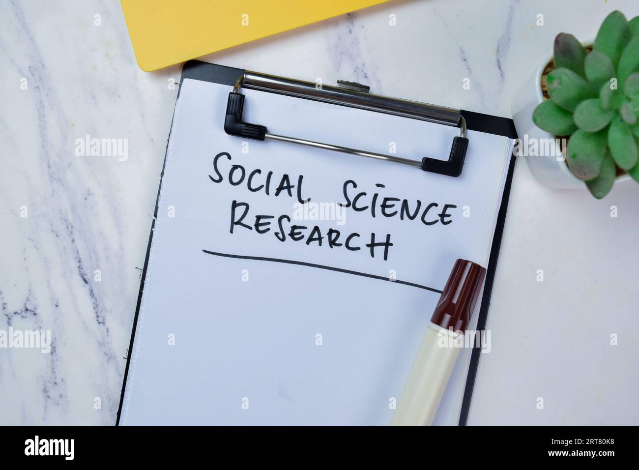 Concept of Social Science Research write on paperwork isolated on Wooden Table. Stock Photo