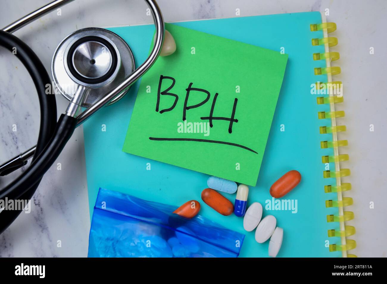 Concept of BPH write on sticky notes with stethoscope isolated on Wooden Table. Stock Photo