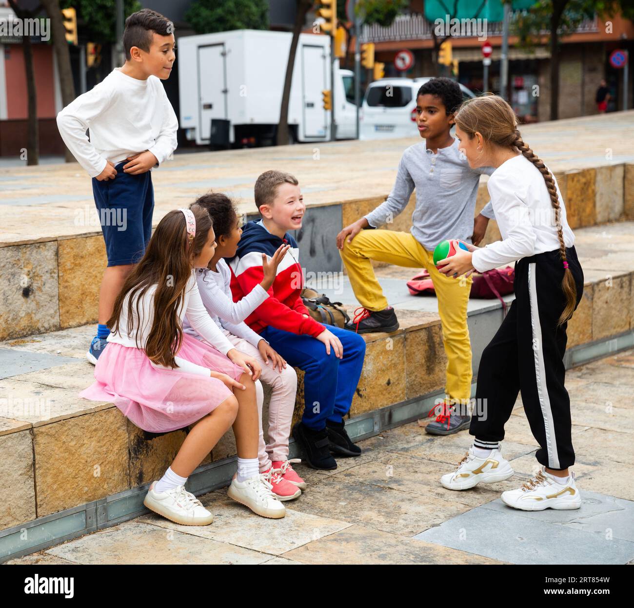 Cheerful tweens spending time together on city street Stock Photo - Alamy