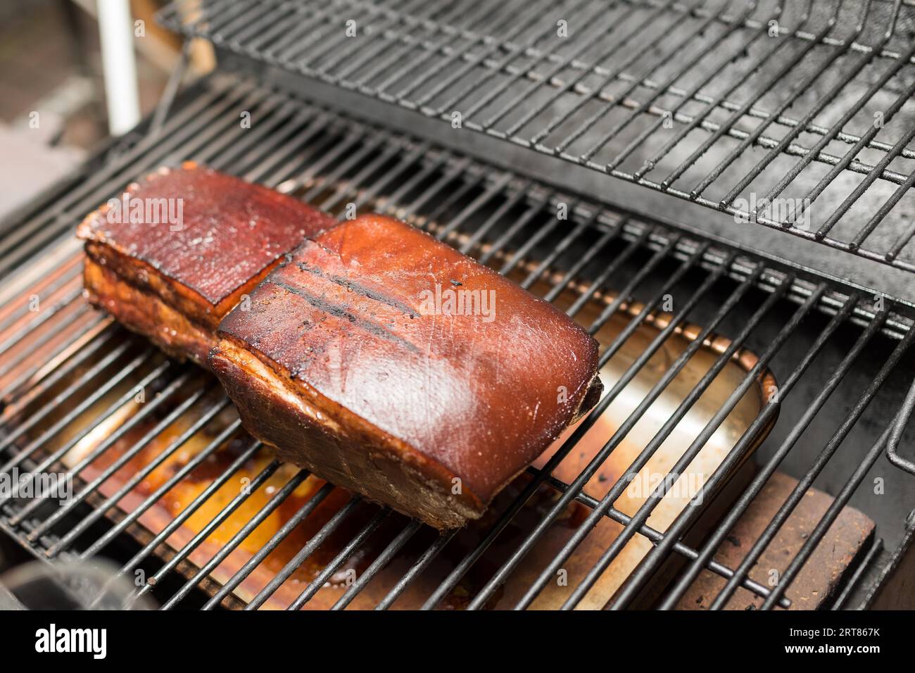 Ready to eat Prague style grilled ham on grid of barbecue smoker Stock ...