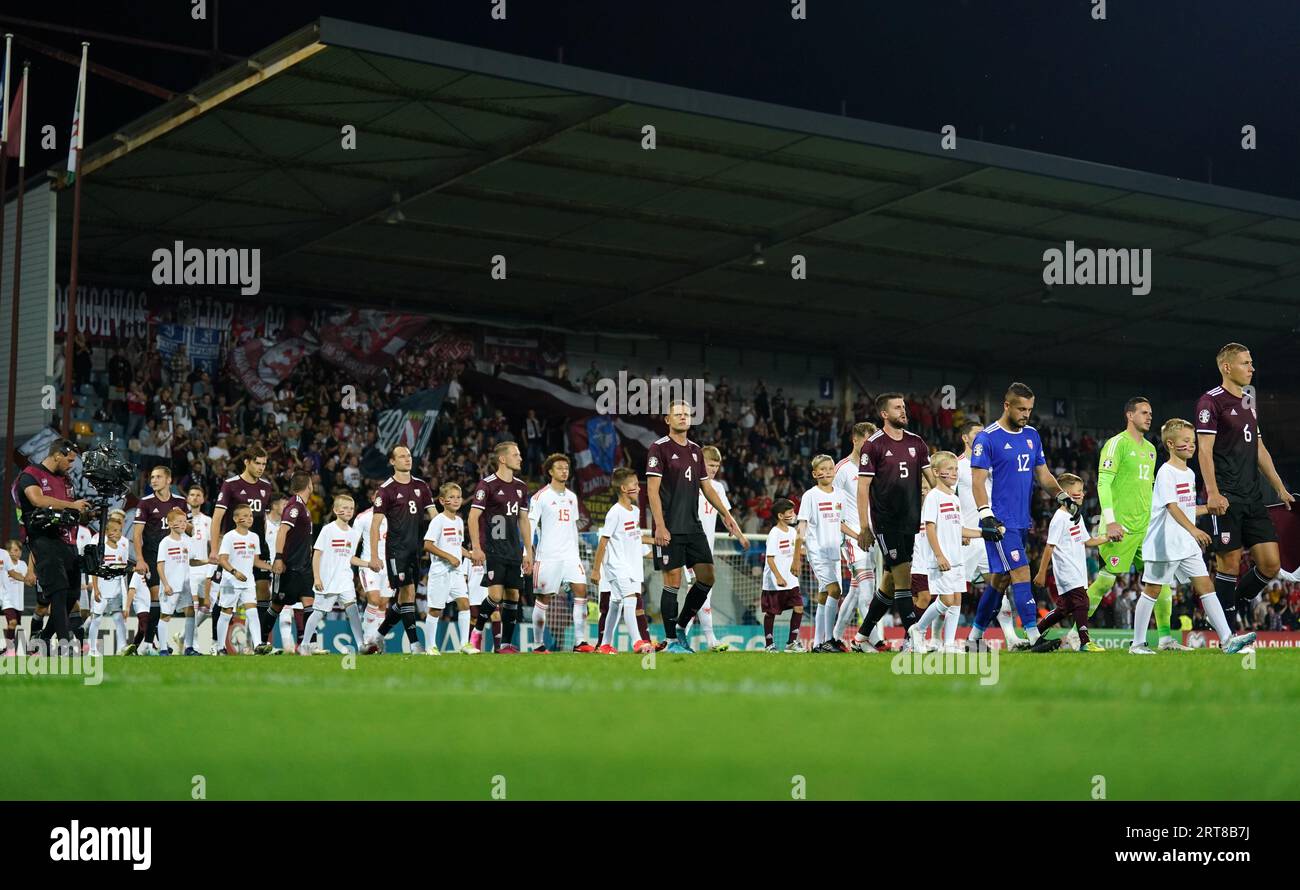 Latvia and Wales walk out for the UEFA Euro 2024 Qualifying Group D match at the Skonto Stadium, Riga. Picture date: Monday September 11, 2023. Stock Photo