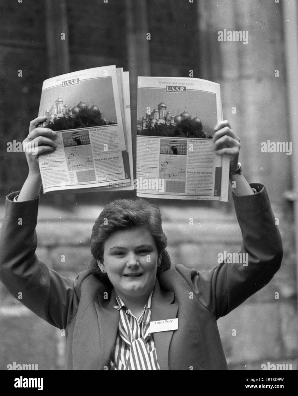 1987, a female travel agent holding up brochures about their new vacation trips to visit the USSR, as the country under its president, Mikhail Gorbachev began to open itself up to visitors and tourists which had previously been denied. Yet only a few years later in December 1991, the Union of Soviet Socialist Republics (USSR), the old Soviet Union, broke up and became 15 independent countries. Stock Photo