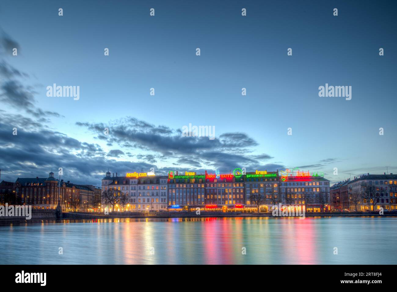 Copenhagen, Denmark, March 2, 2017: Evening view over the Lakes with the famous illuminated advertisement signs on buildings Stock Photo