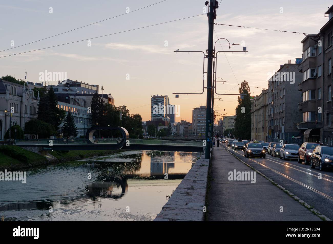 Bridge over the River Miljacka and traffic on a roas on a summers evening the city of Sarajevo, Bosnia and Herzegovina, September 11, 2023 Stock Photo