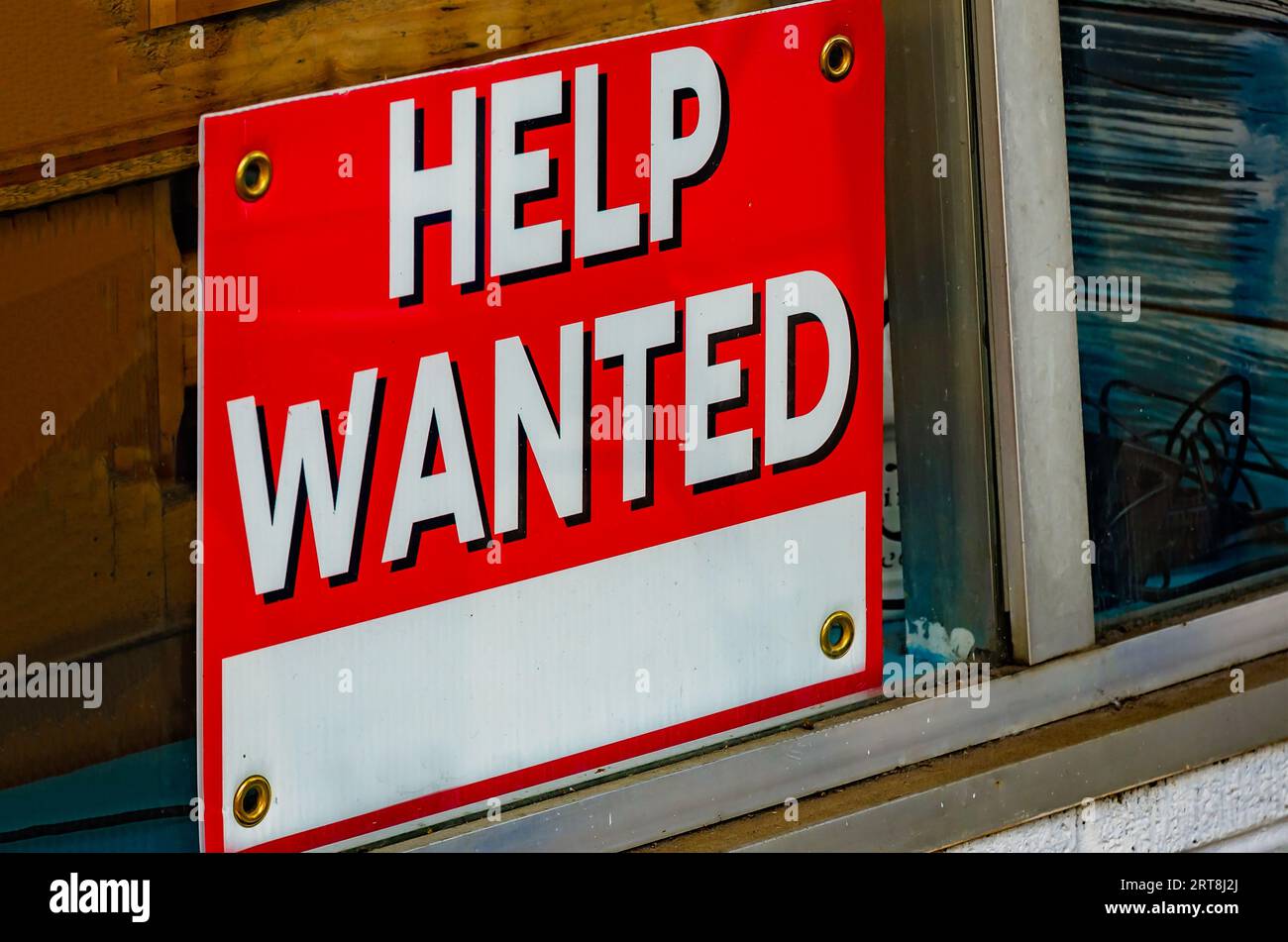 A help wanted sign stands in the window of a coffee shop, Aug. 19, 2023, in Foley, Alabama. Approximately 8.8 million job openings are unfilled. Stock Photo