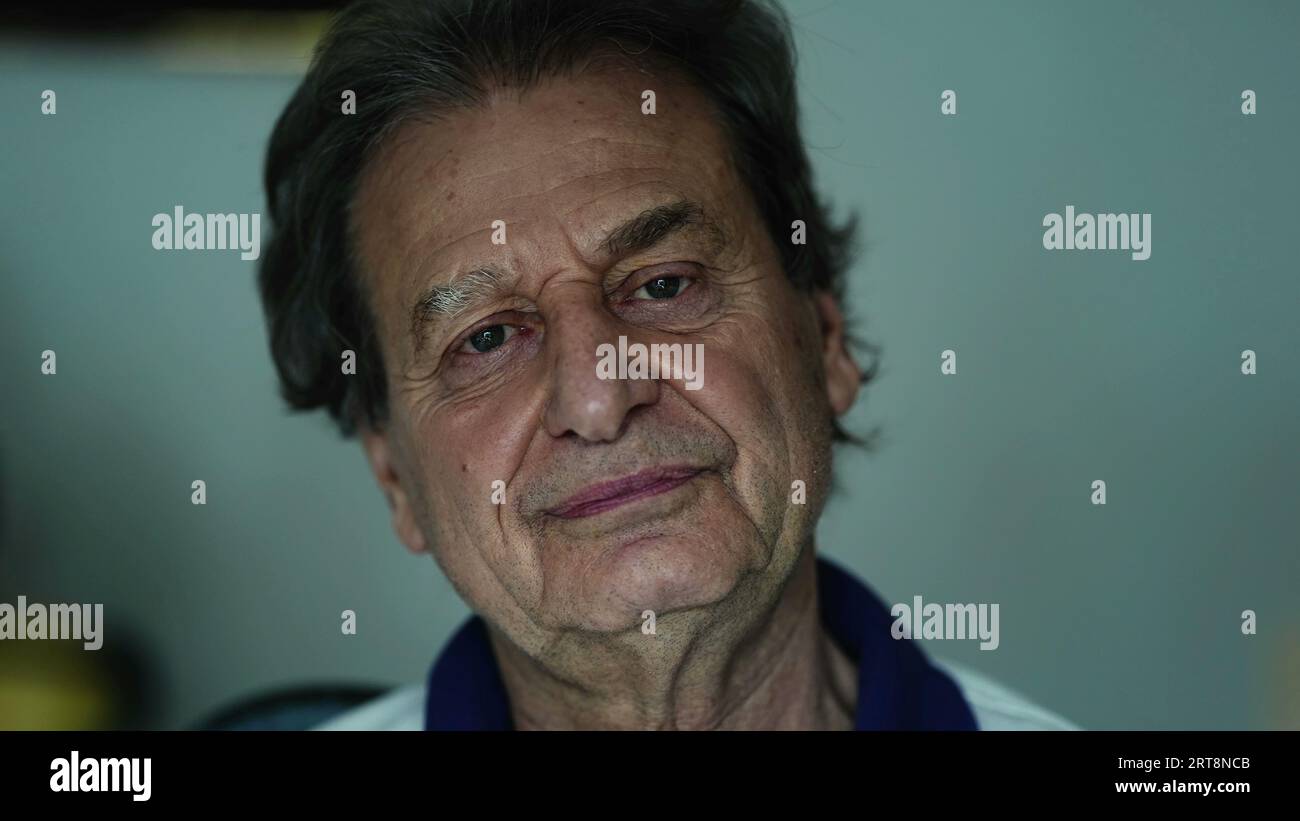 Portrait of a happy senior man close-up face, elderly caucasian person in 70s looking at camera chuckling Stock Photo