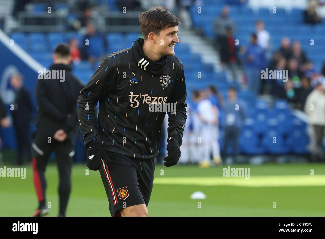 Harry Maguire warms up before kick off for Manchester United at the AMEX Stadium Stock Photo
