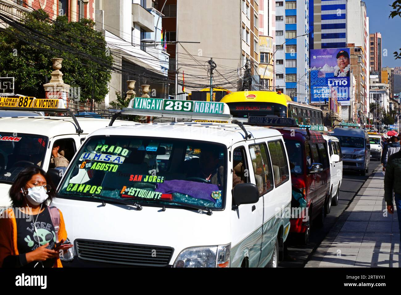 La Paz, BOLIVIA; September 11th 2023: Traffic jams on Av 6 de Agosto in central La Paz, with Bolivian president Luis Arce Catacora on a hoarding promoting the 'Industrialisation of lithium, a big step towards a sustainable future for Bolivia' in the background. Bolivia has some of the world's largest lithium reserves in the Salar de Uyuni salt flat, the development of which is central to the govenrnment's economic policy. This year Bolivia has signed agreements with the Chinese battery maker CATL and the Citic Guoan Group, and Russian state firm Rosatom to develop these resources. Stock Photo