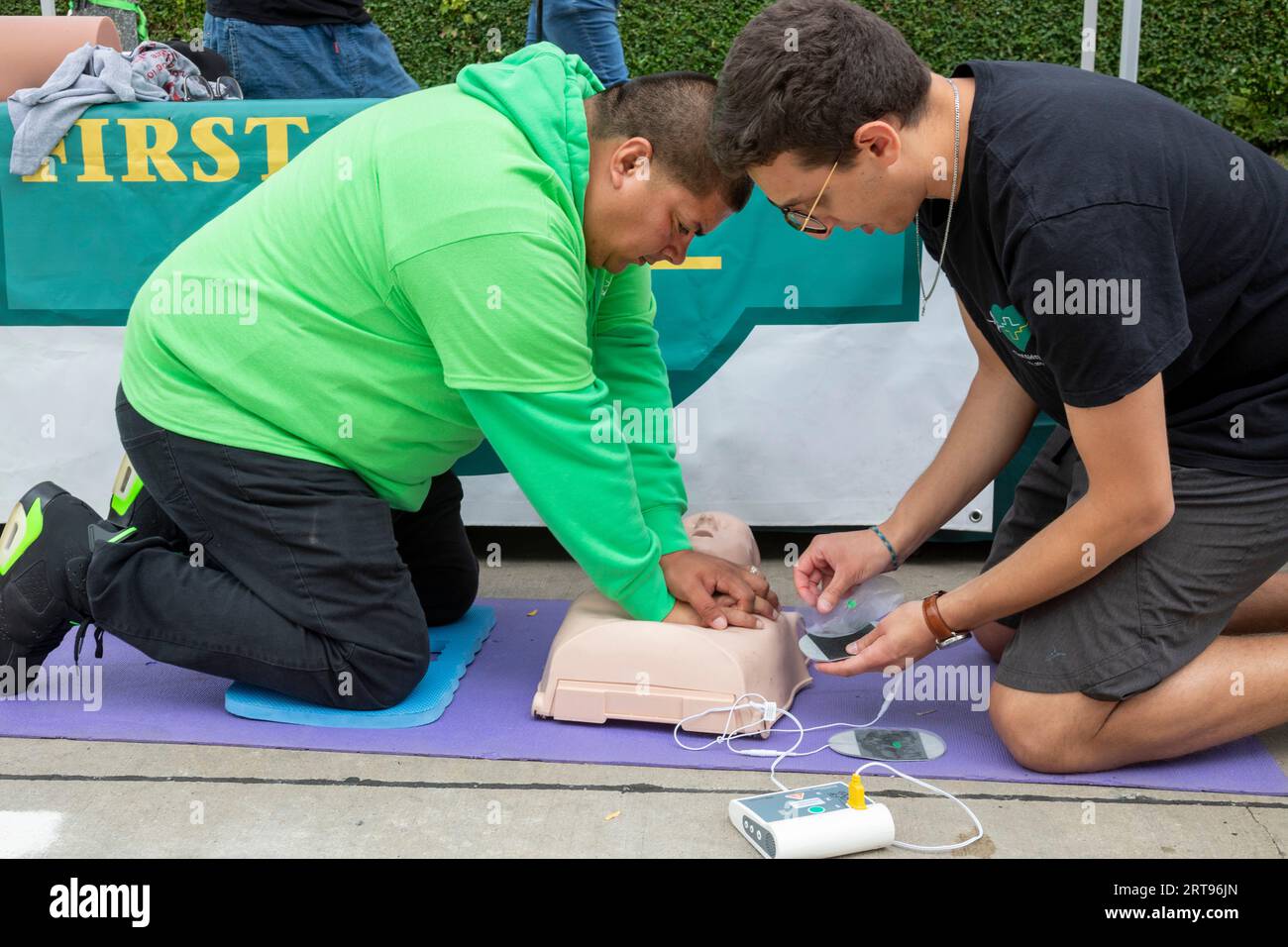 Detroit, Michigan - At a block party sponsored by the Detroit Health Department, a man learns how to help a victim of sudden cardiac arrest using an C Stock Photo