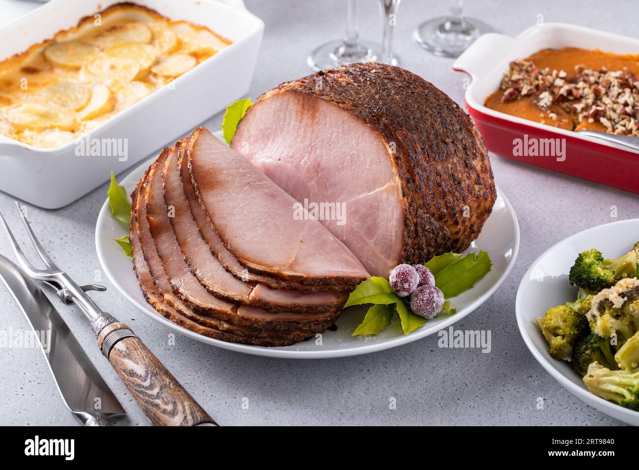 Honey glazed spiral sliced ham with side dishes for a celebration