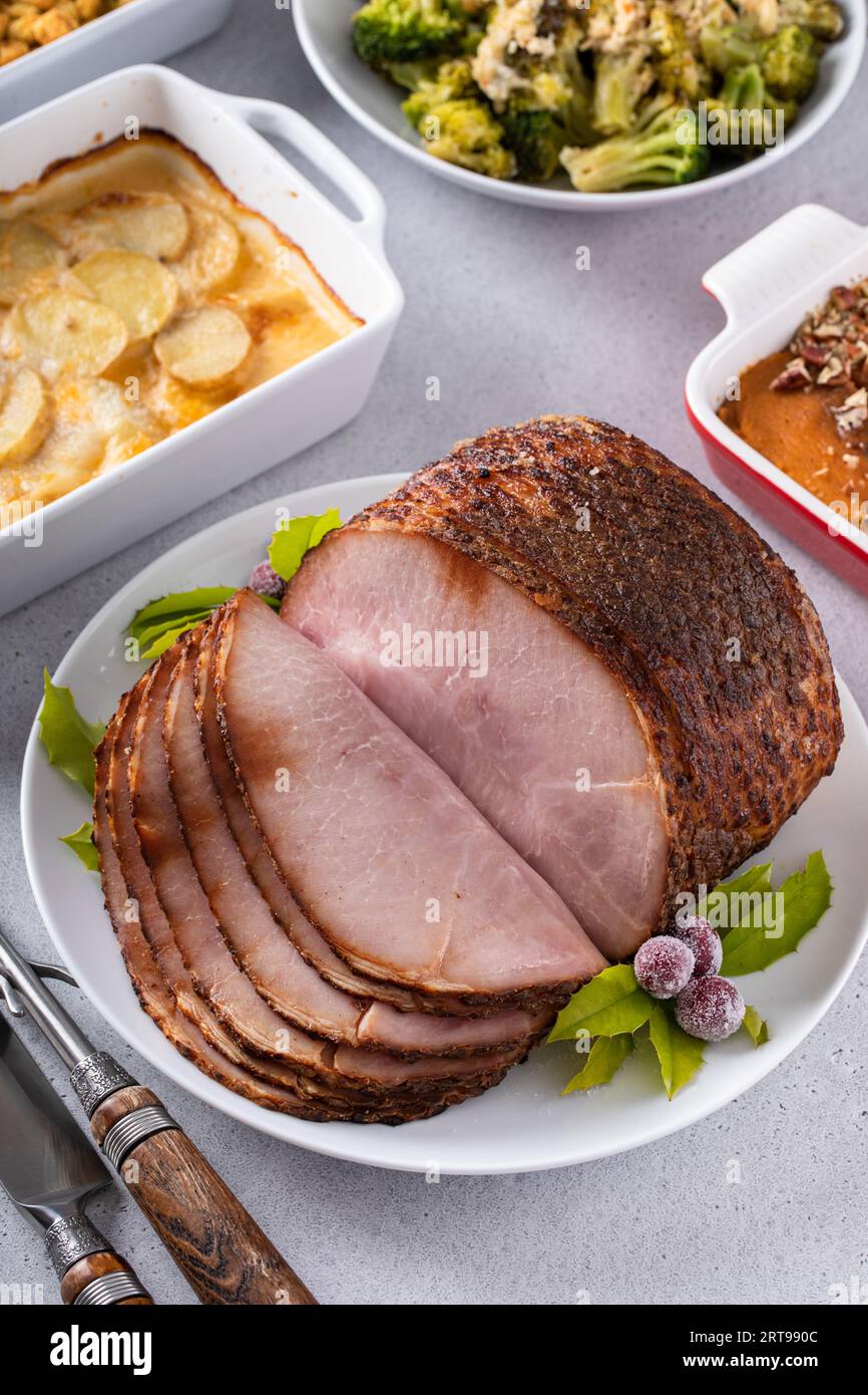 https://c8.alamy.com/comp/2RT990C/honey-glazed-spiral-sliced-ham-with-side-dishes-for-a-celebration-dinner-on-thanksgiving-or-christmas-2RT990C.jpg