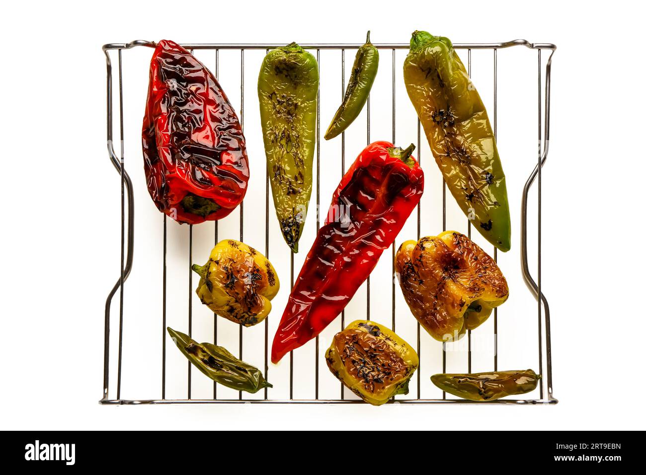 Cooling rack with different grilled peppers on white background Stock ...