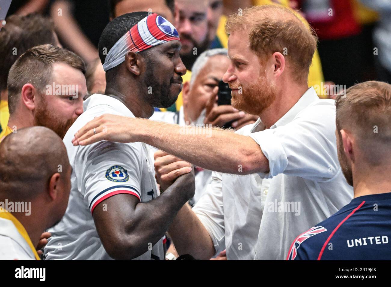 Düsseldorf, Germany. 11th Sep, 2023. Harry hugs  Tech Sgt. Kevin Greene, Captain of Team US. The Duke of Sussex, Prince Harry watches the game and interacts with invitees, fans, children and even a UK athlete's sausage dog, before handing Team USA their gold medals after their win. Team United Kingdom play Team USA in the wheelchair rugby finals at the Spiel Merkur arena this evening. Day 2 of the Invictus Games Düsseldorf in and around the Merkur Spiel Arena. Credit: Imageplotter/Alamy Live News Stock Photo