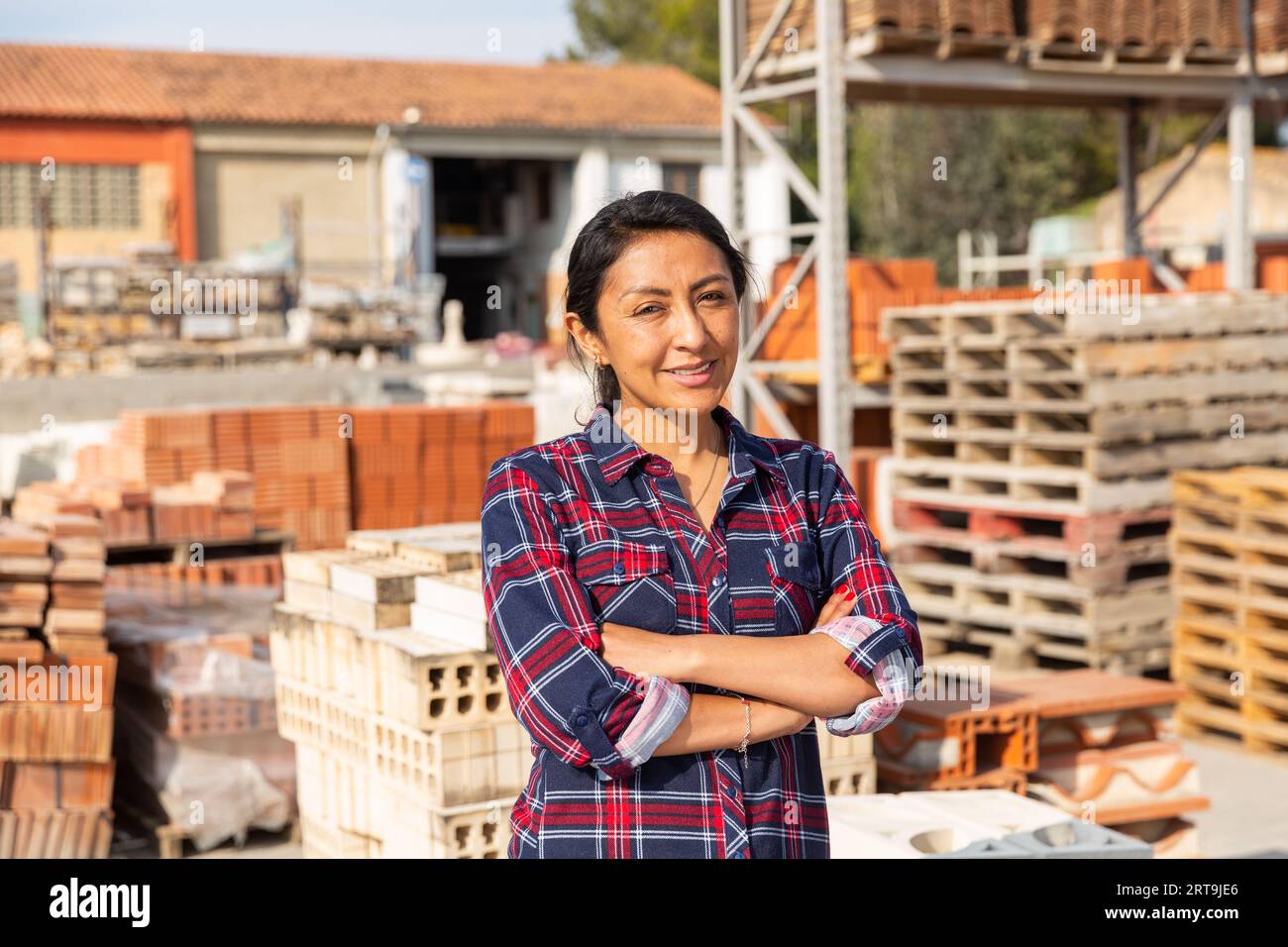 Woman worker posing at building materials warehouse Stock Photo