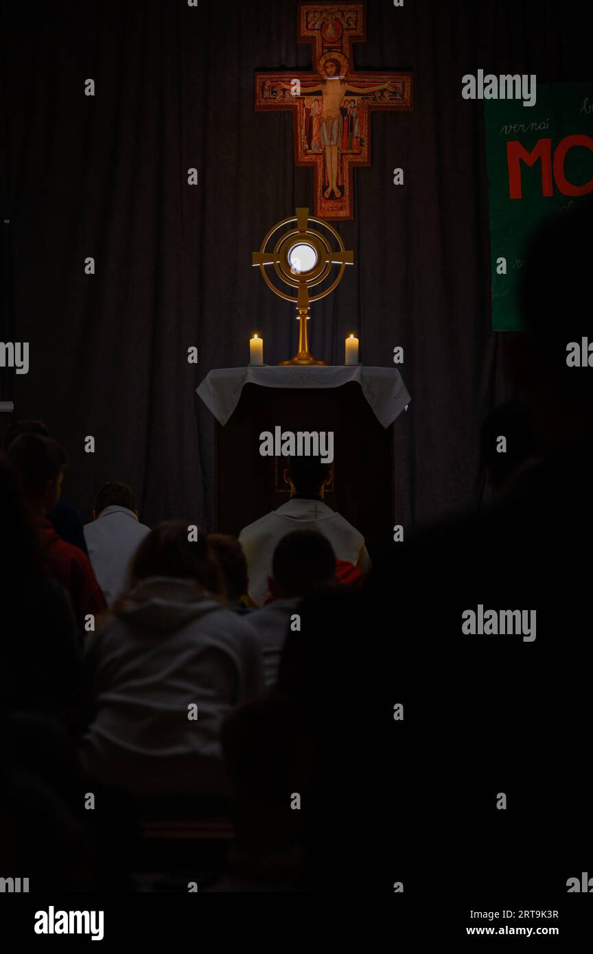 Young people adoring Jesus in the Blessed Sacrament on a pilgrimage event in Vysoká nad Uhom, Slovakia. Stock Photo