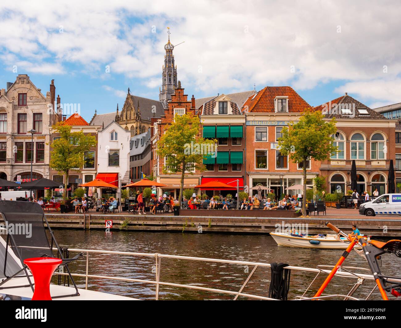 View from pleasure boat of Haarlem waterfront on Spaarne river with Sint-Bavokerk church belfry Stock Photo