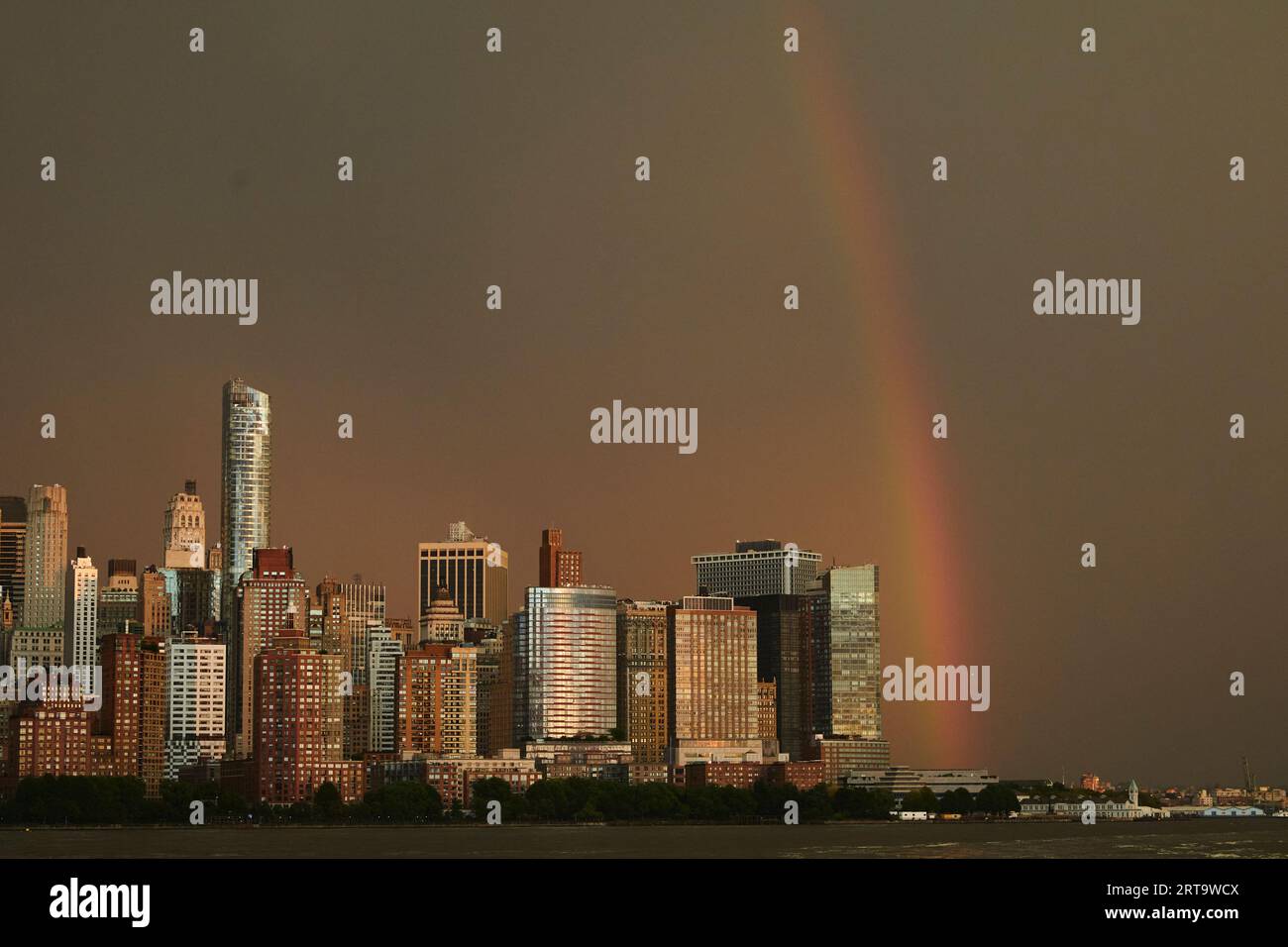 A rainbow is seen in the sky above Lower Manhattan area of New York ...