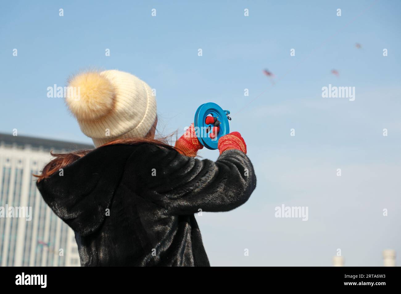 Luannan county - February 22, 2018: people fly kites in the square, luannan county, hebei province, China. Stock Photo
