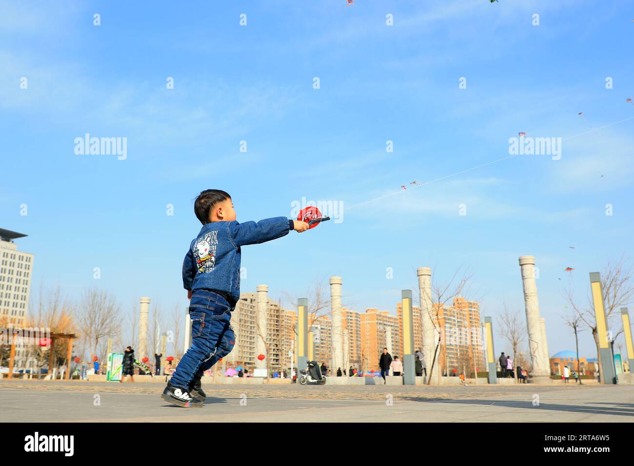 Luannan county - February 22, 2018: people fly kites in the square, luannan county, hebei province, China. Stock Photo