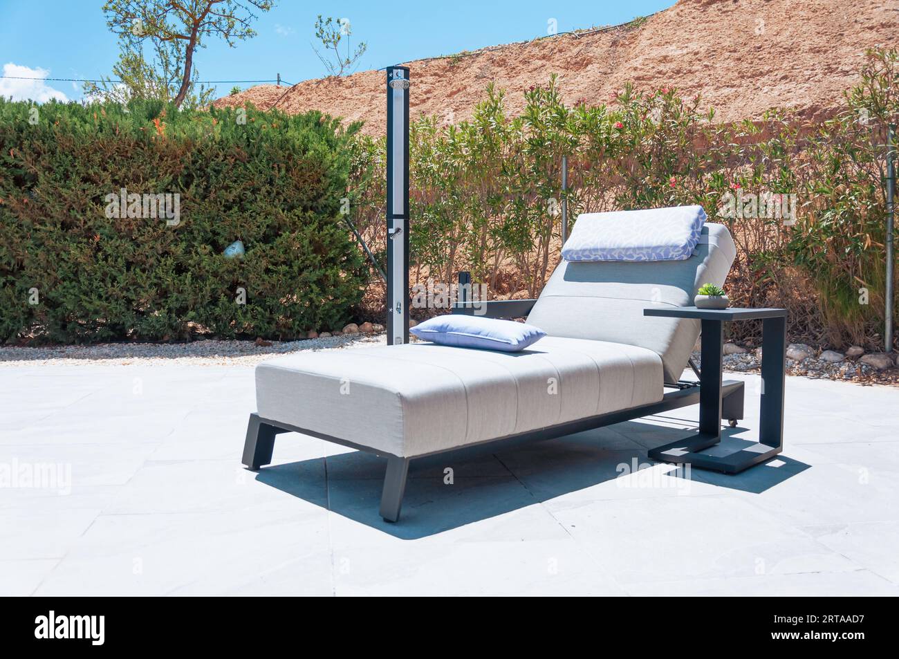 modern sun lounger in an expensive hotel closeup around greenery and