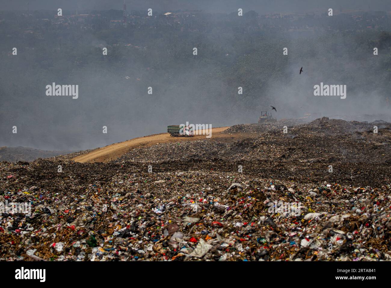 Bandung, West Java, Indonesia. 12th Sep, 2023. An exavator and truck