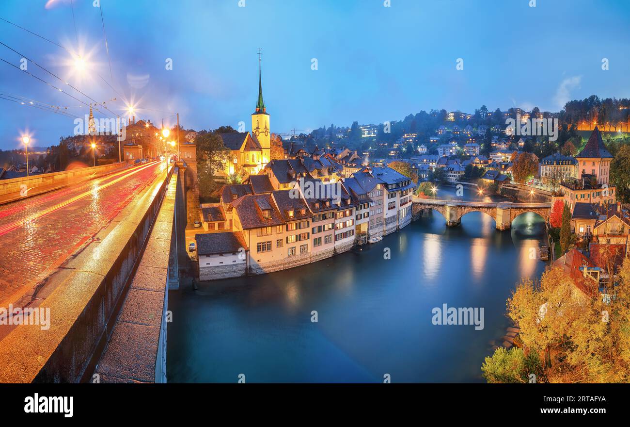 Incredible  autumn view of Bern city at night. Scene of Aare river with Nydeggkirche - Protestant church. Location: Bern, Canton of Bern, Switzerland, Stock Photo