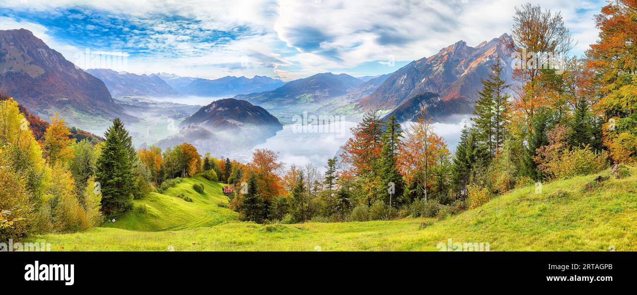 Outstanding  autumn view on suburb of Stansstad city  and Lucerne lake with mountaines and fog. Poppular travel destination in Swiss Alps.   Location: Stock Photo