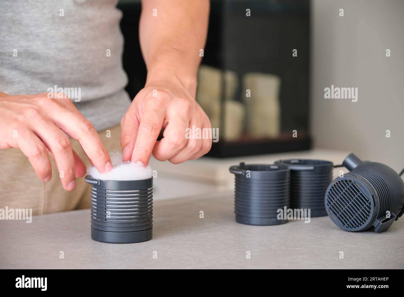 Man hand setting up new fish tank filter wool for mechanical prefiltration Stock Photo Alamy