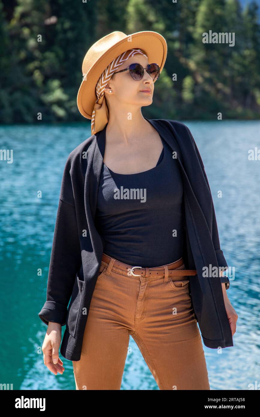Woman tourist vertical portrait on Kolsay lake in Kolsai Koldery gorge, nature of Kazakhstan National Park Stock Photo